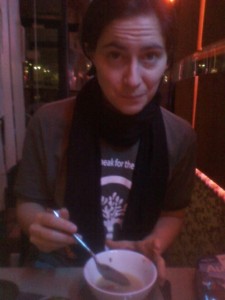 cute woman eating Nepali momo soup in NYC